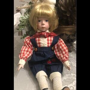 17’’ PORCELAIN DOLL ,GLASS BLUE EYES W/JUMPER, VINTAGE COLLECTIBLE.